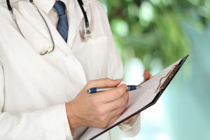 young medical doctor with a stethoscope around his neck holding a black folder